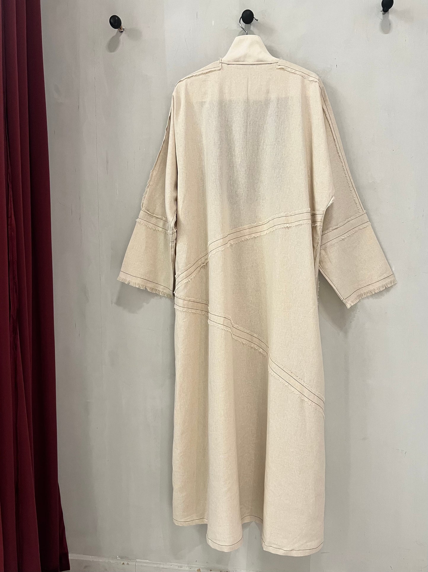 Abaya - Soft natural beige tone, delicate contrast stitching and subtle raw-edge detailing