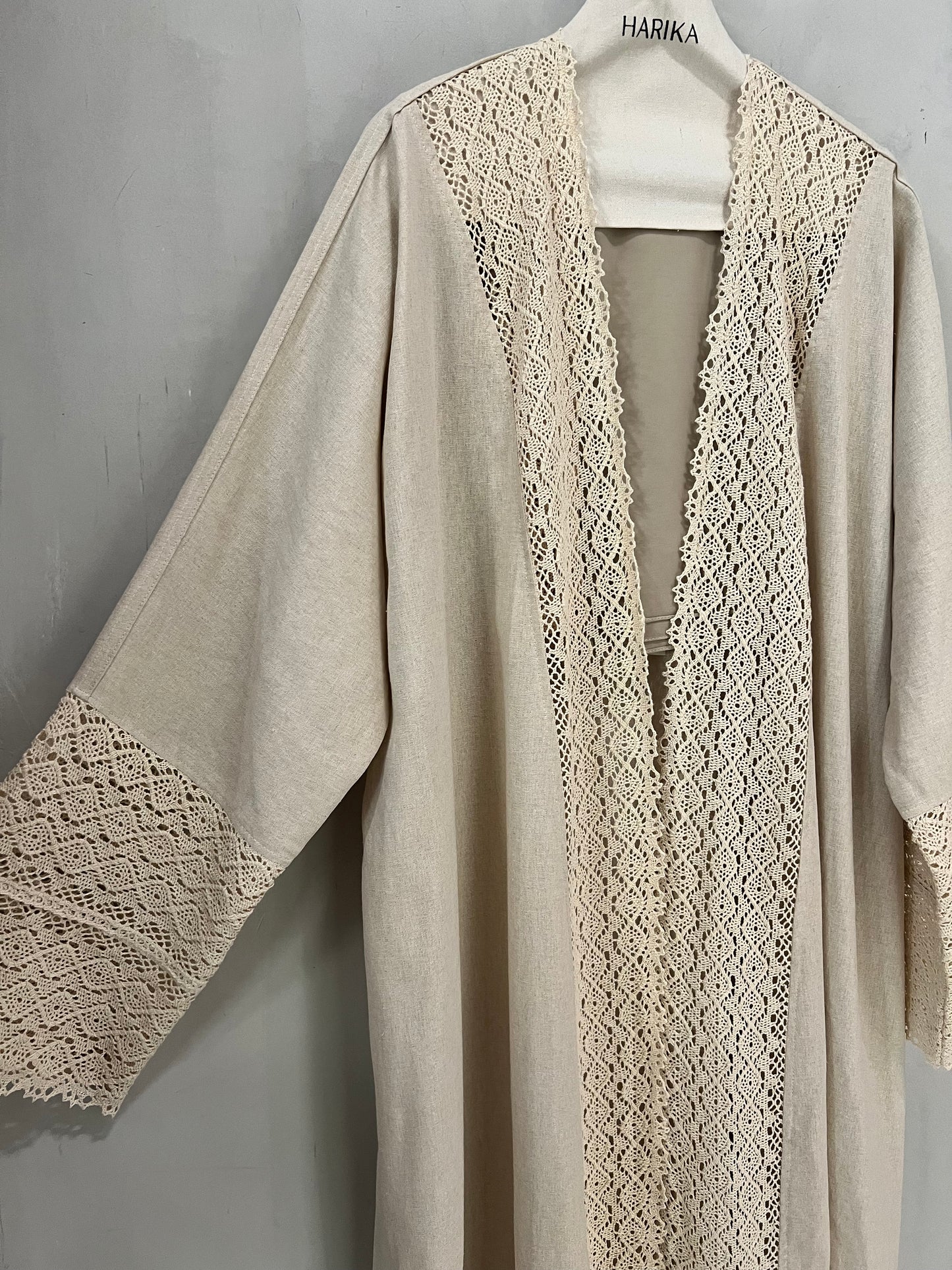 Abaya - Soft neutral beige tone, beautifully detailed with delicate crochet lace accents along the front panel and sleeves for a graceful feminine touch
