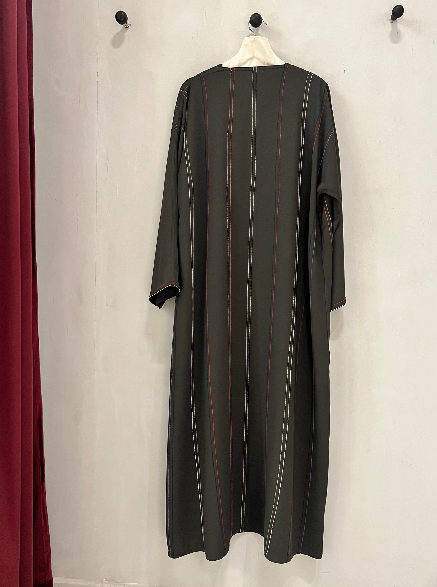Abaya - Crafted in a timeless black shade with delicate vertical stripe accents