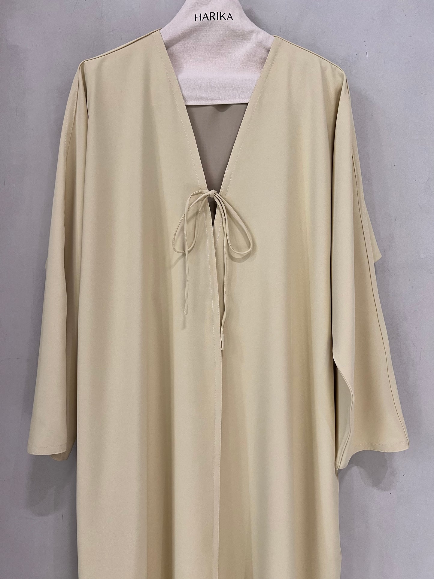 Abaya - Butter yellow, a deep V-neckline adorned with delicate tie-front bows