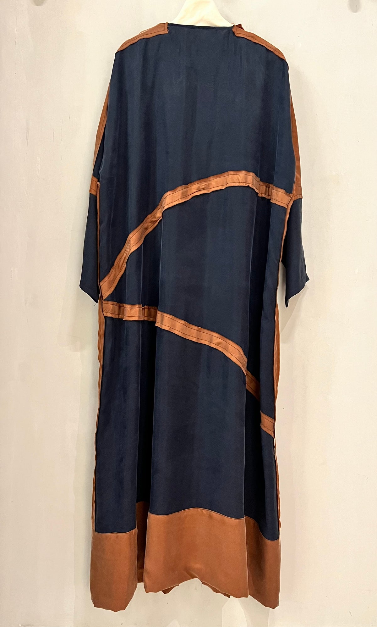 Abaya- A sophisticated deep navy accented with warm copper detailing