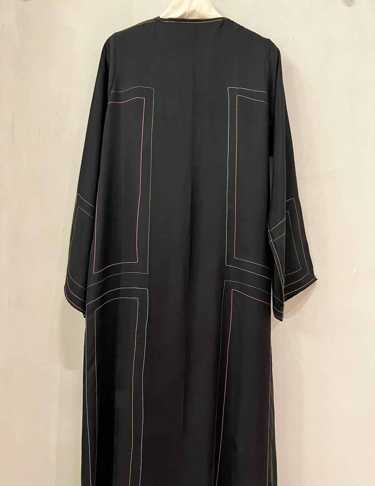 Abaya- A sophisticated black abaya featuring elegant contrasting linear stitching