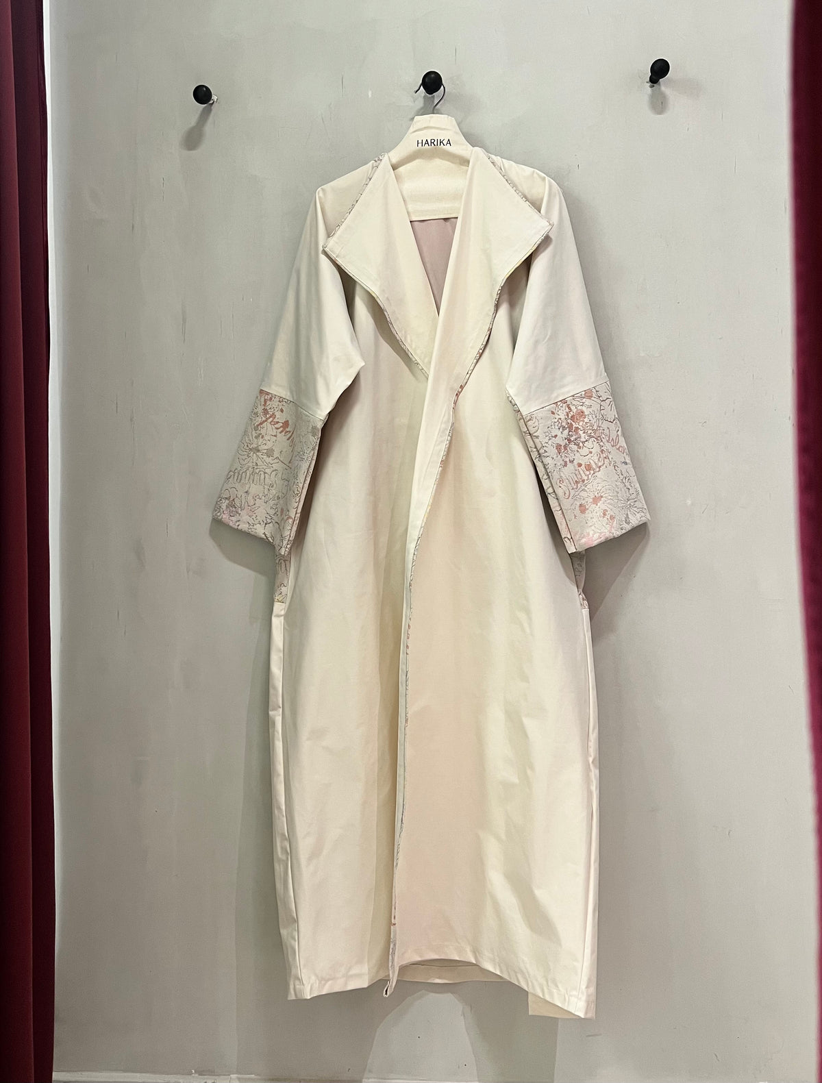 Abaya- stunning ivory abaya, featuring a sophisticated open-front design and beautifully detailed floral-patterned cuffs in soft blush pink and muted beige tones