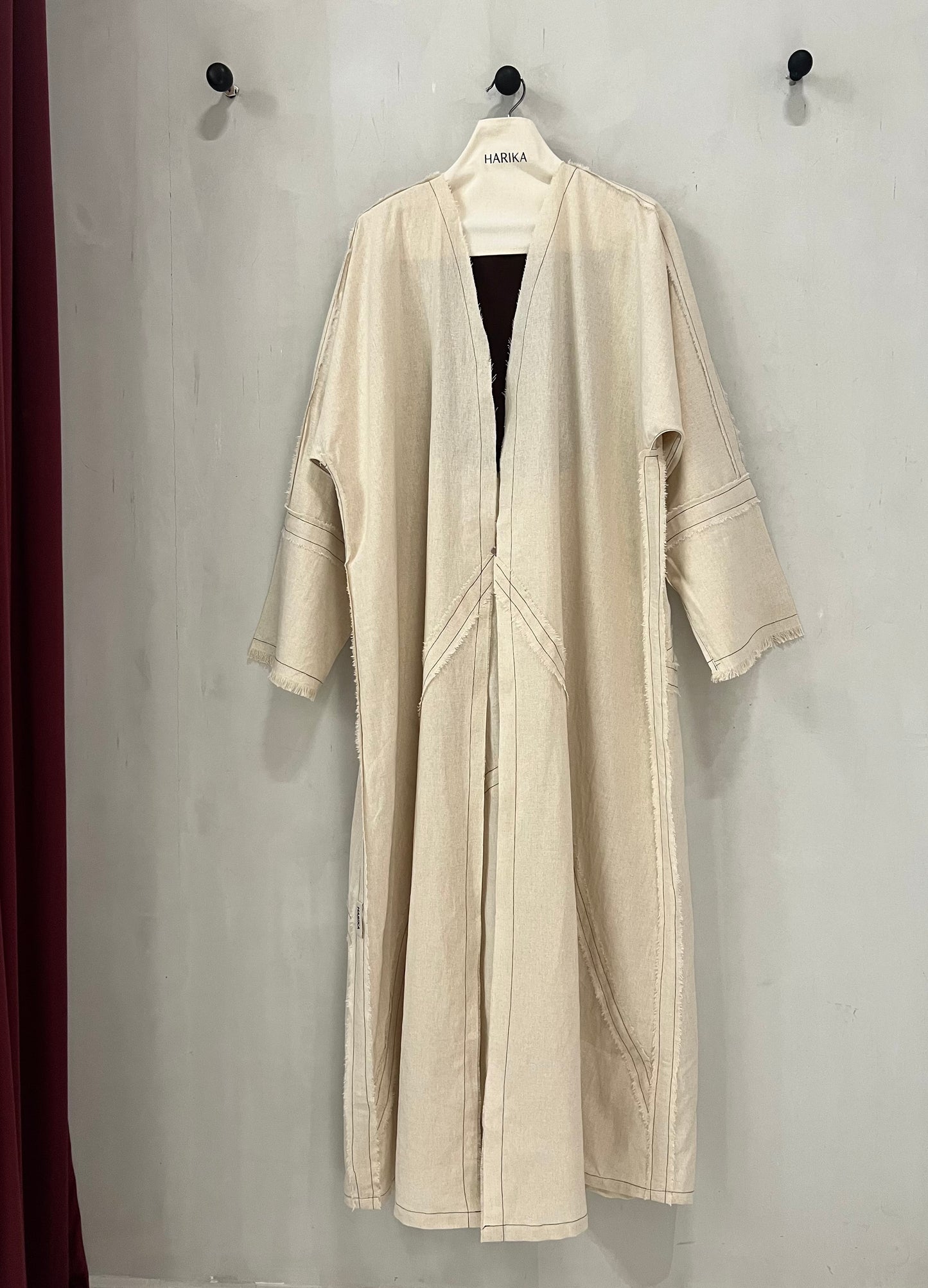 Abaya - Soft natural beige tone, delicate contrast stitching and subtle raw-edge detailing