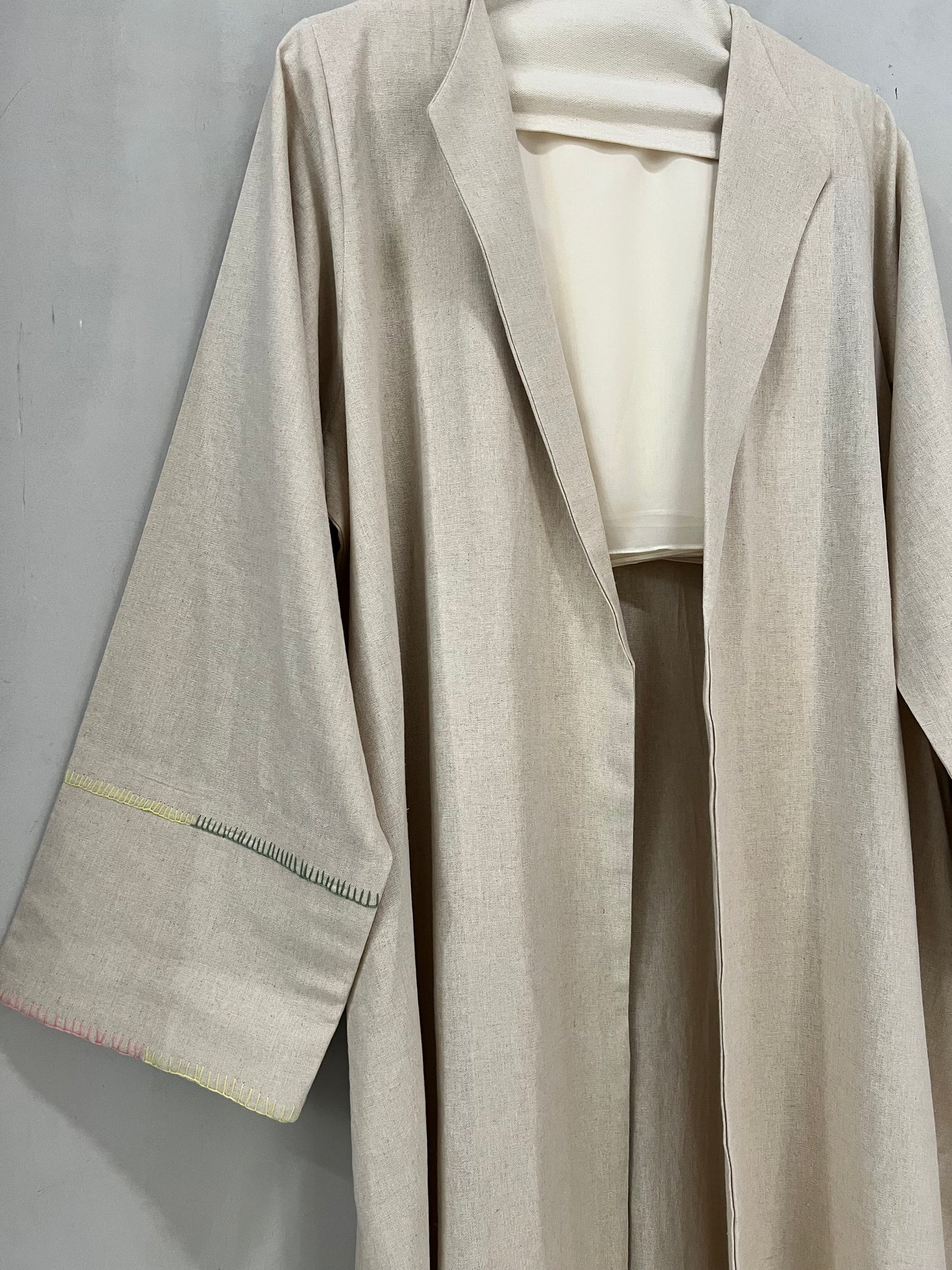 Abaya - Soft oatmeal beige tone, designed with a modern tailored lapel collar and wide relaxed sleeves