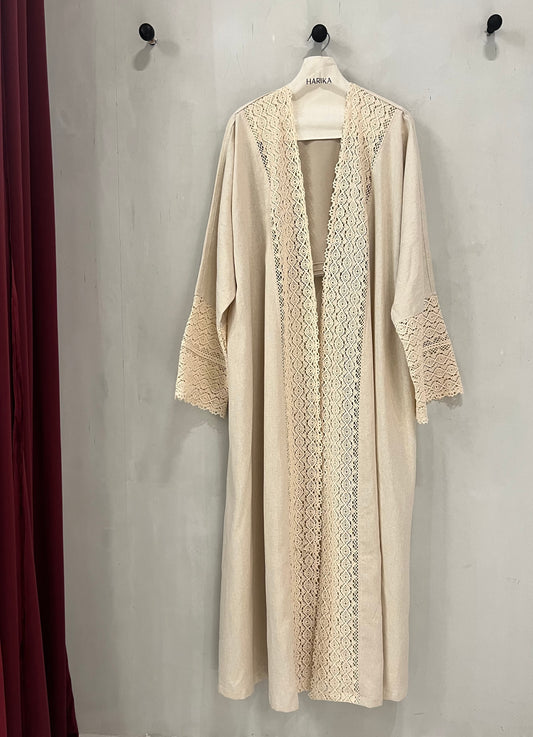 Abaya - Soft neutral beige tone, beautifully detailed with delicate crochet lace accents along the front panel and sleeves for a graceful feminine touch