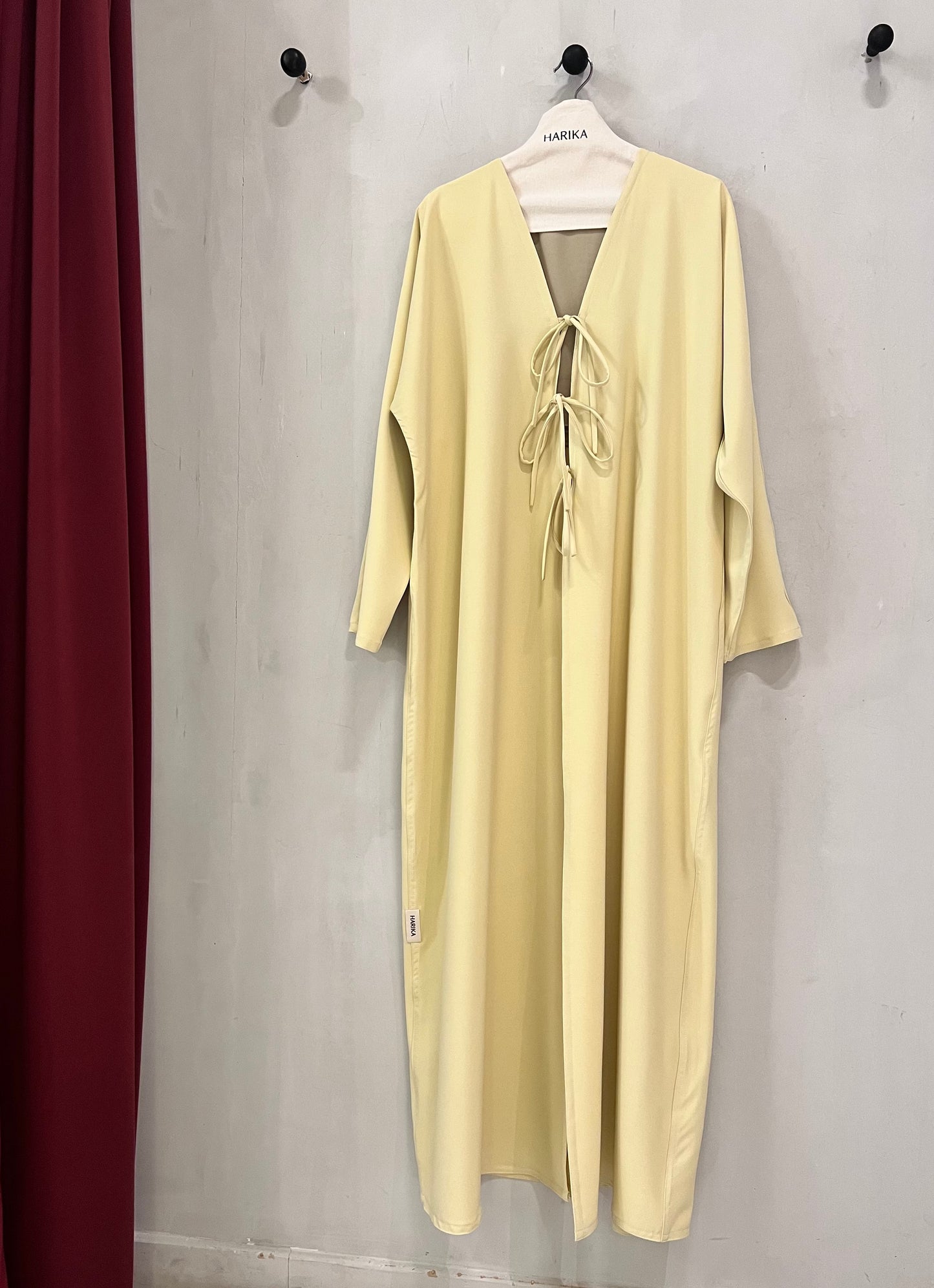 Abaya - Butter yellow, a deep V-neckline adorned with three delicate tie-front bows