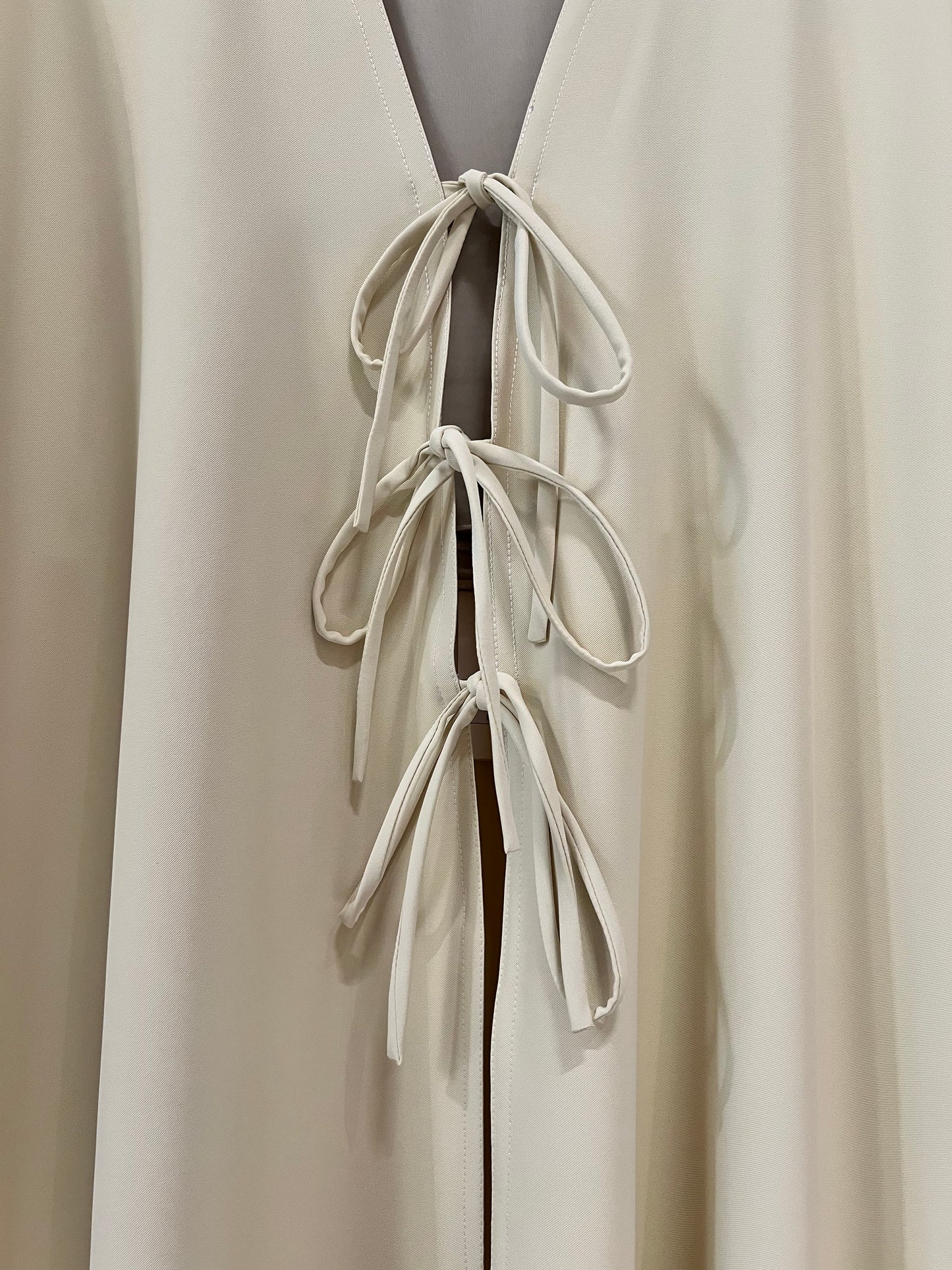 Abaya - Butter yellow, a deep V-neckline adorned with three delicate tie-front bows