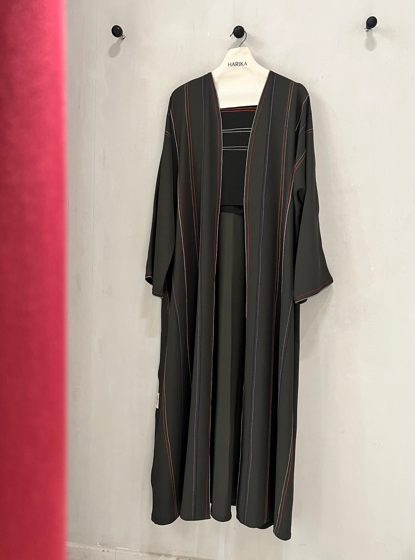 Abaya - Crafted in a timeless black shade with delicate vertical stripe accents