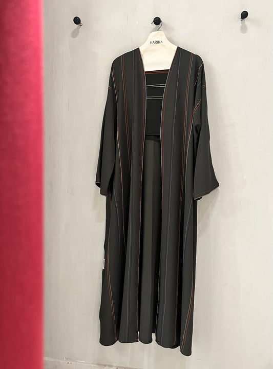 Abaya - Crafted in a timeless black shade with delicate vertical stripe accents