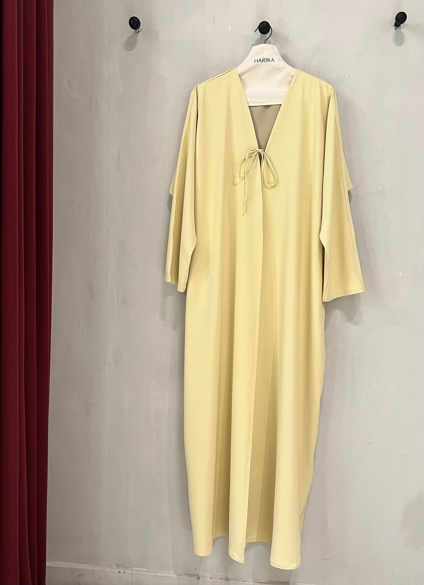 Abaya - Butter yellow, a deep V-neckline adorned with delicate tie-front bows