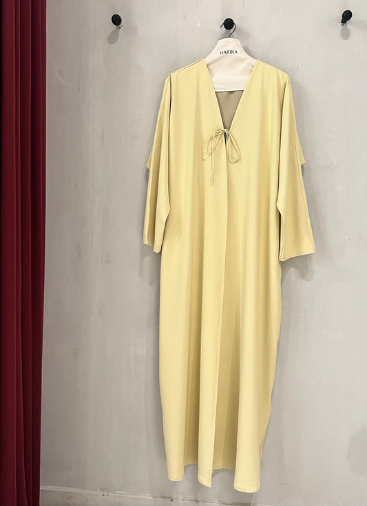 Abaya - Butter yellow, a deep V-neckline adorned with delicate tie-front bows