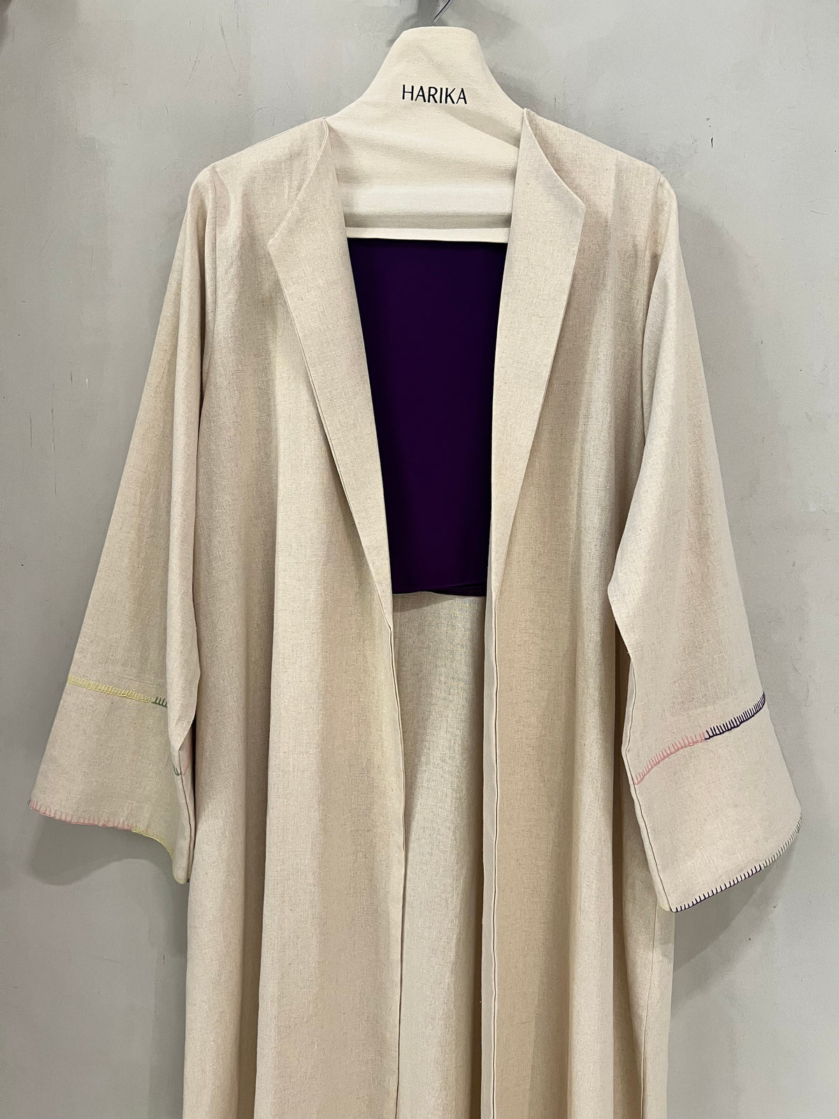 Abaya - Soft oatmeal beige tone, designed with a modern tailored lapel collar and wide relaxed sleeves