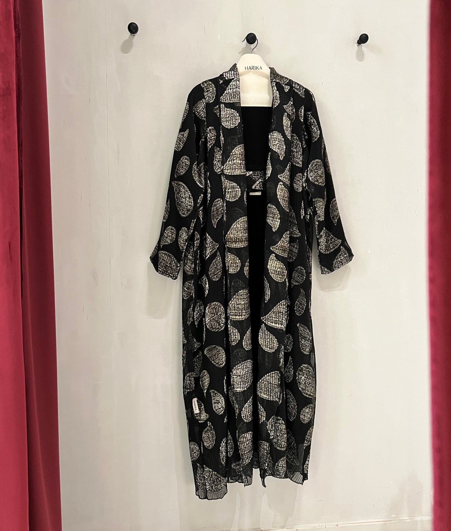 Abaya- a striking abstract leaf pattern in soft beige against a classic black backdrop