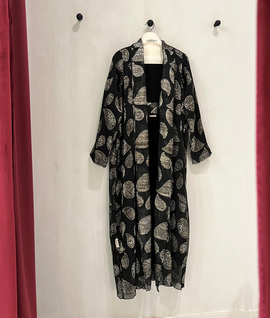 Abaya- a striking abstract leaf pattern in soft beige against a classic black backdrop