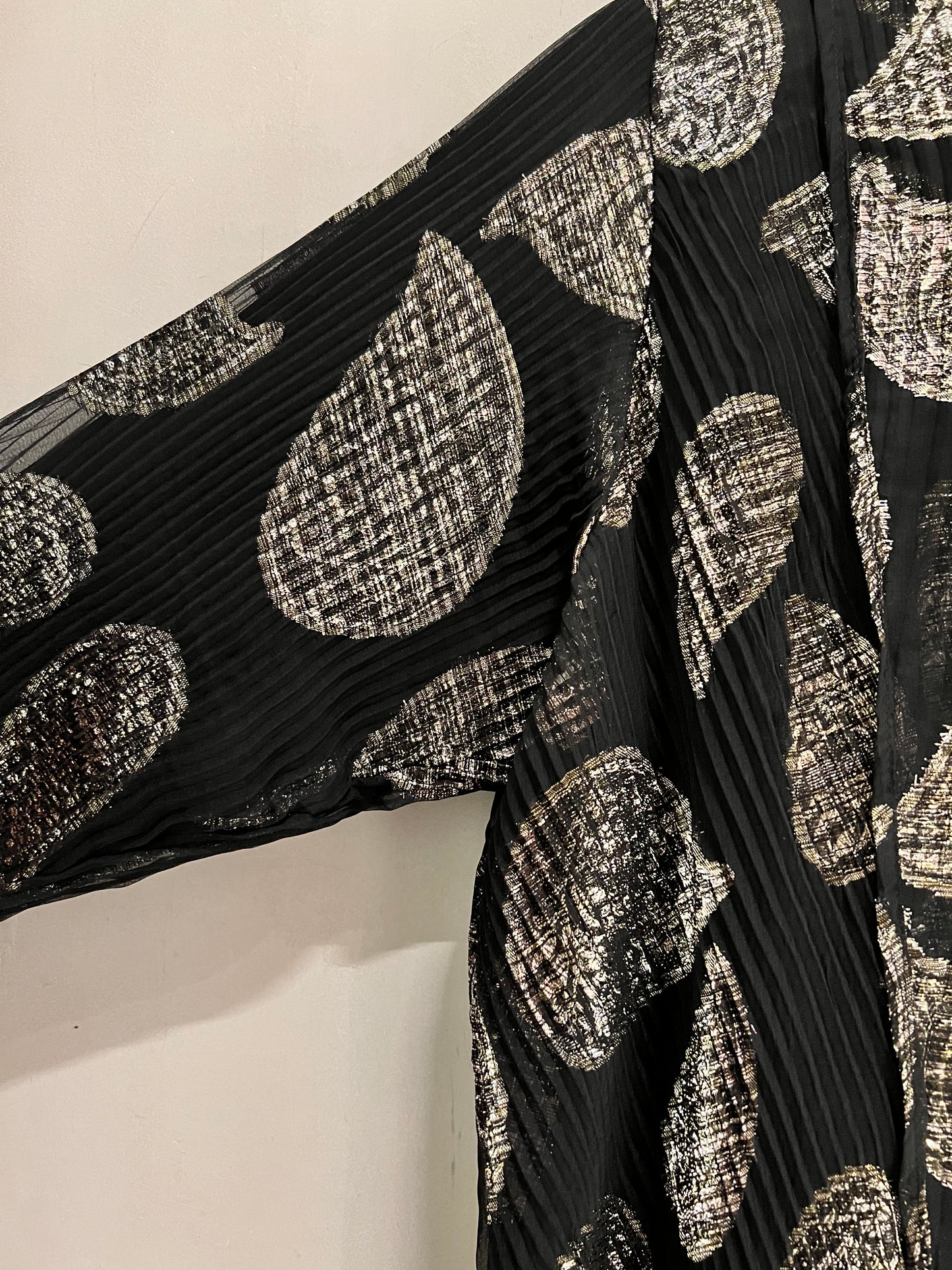 Abaya- a striking abstract leaf pattern in soft beige against a classic black backdrop