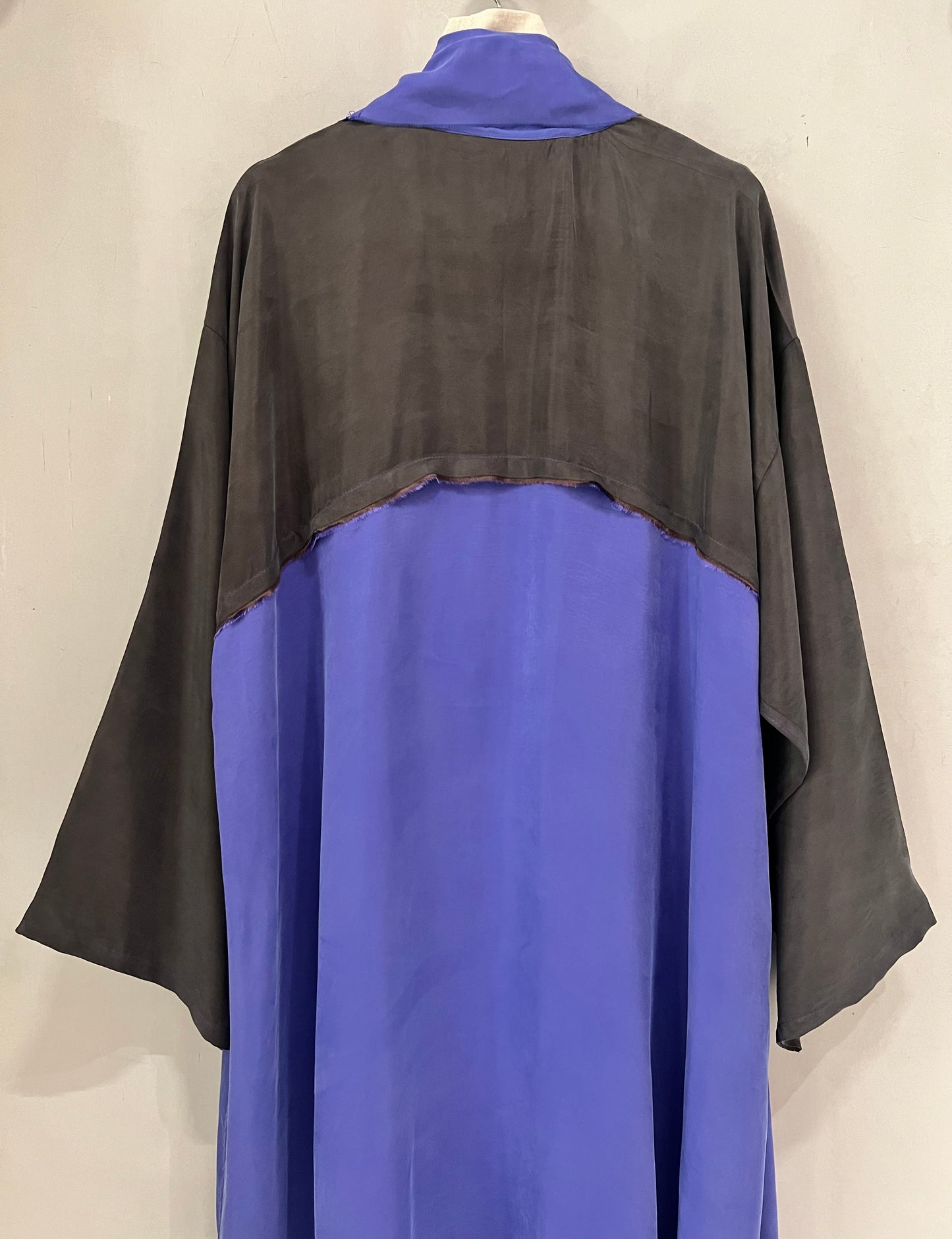 Abaya- a flowing amethyst purple accented with sleek black sleeves and shoulder panels