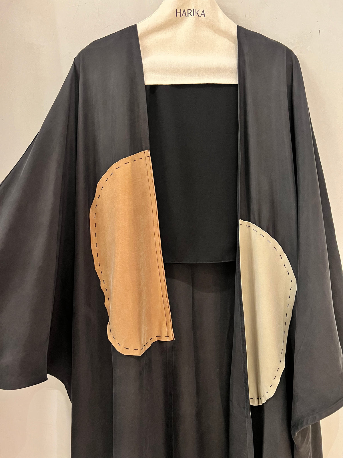 Abaya- Modern black with contrasting tan and ivory curved panel details, finished with visible decorative stitching