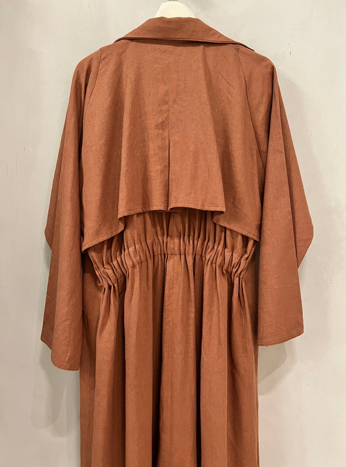Abaya- A caramel-toned abaya designed in a modern trench-coat silhouette with an elastic waist detail