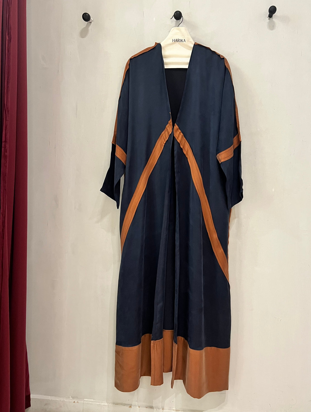 Abaya- A sophisticated deep navy accented with warm copper detailing
