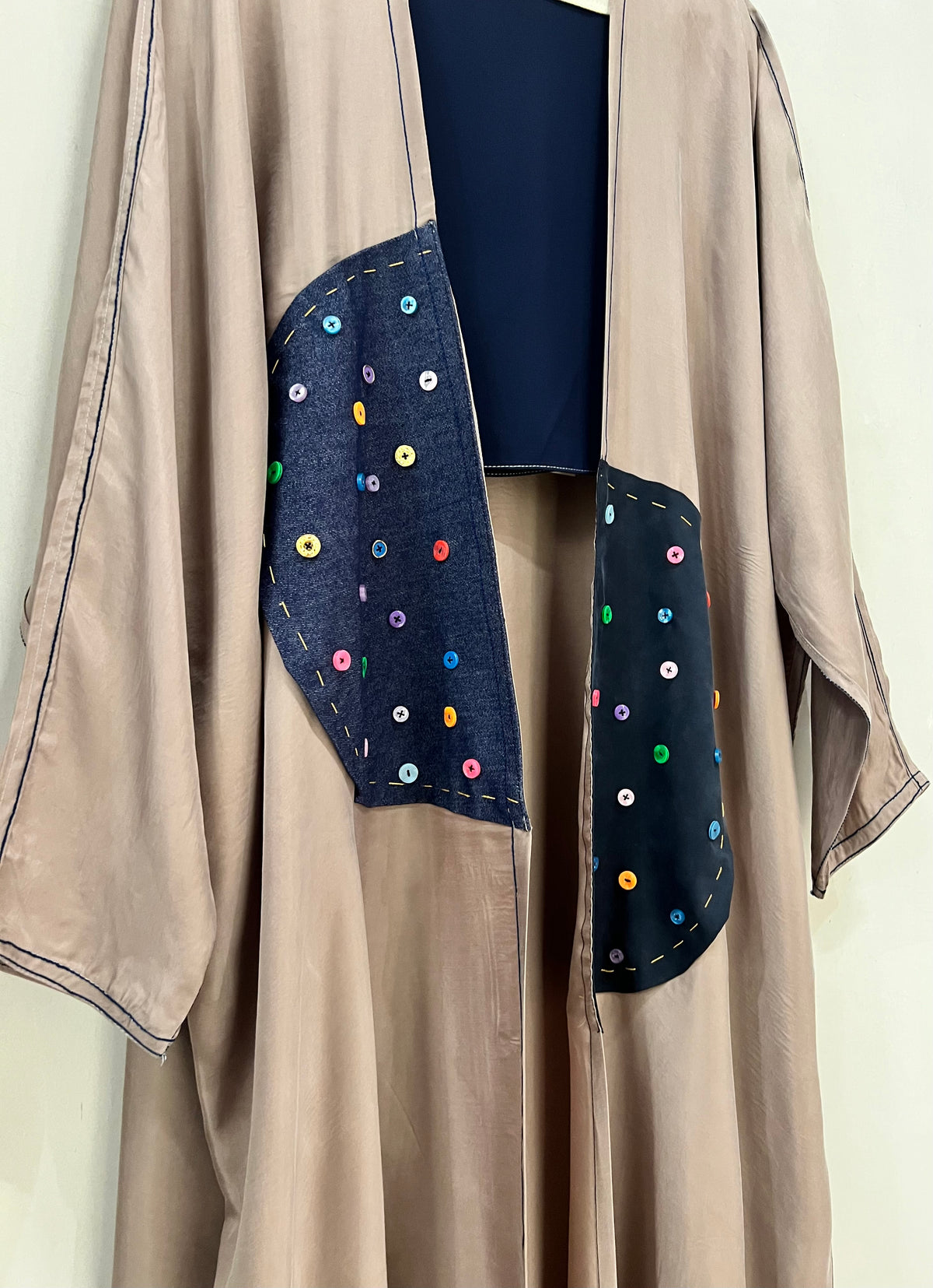 Abaya- A soft taupe-brown, layer in a deep navy with colored buttons accent