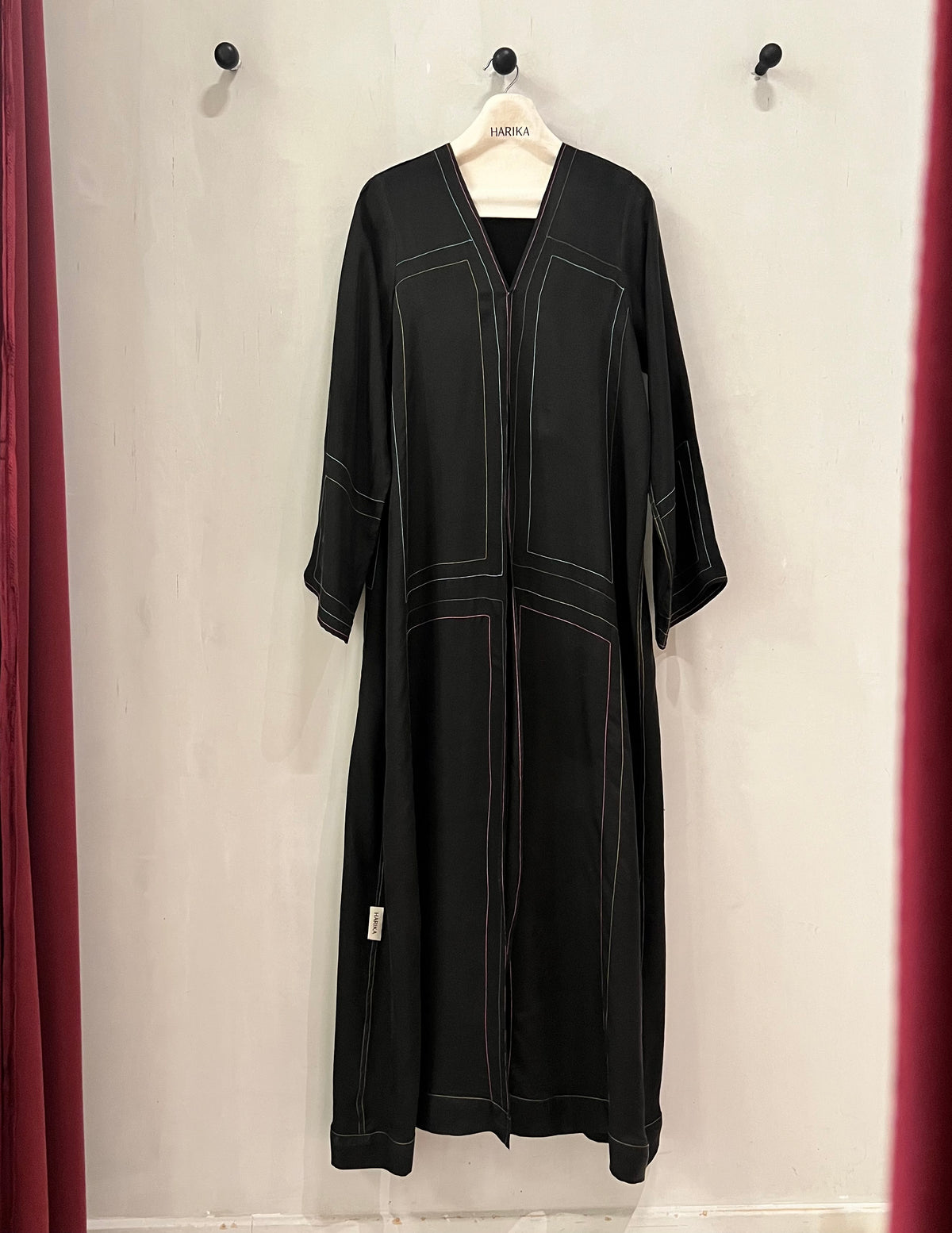 Abaya- A sophisticated black abaya featuring elegant contrasting linear stitching